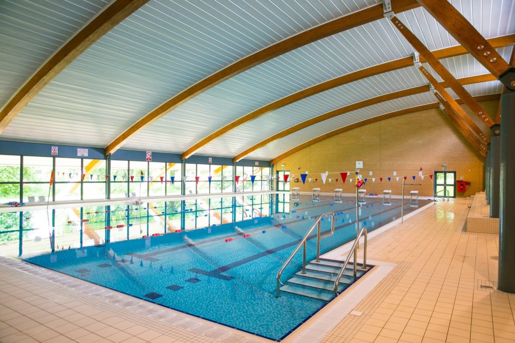 Olympic sized swimming pool with white, red, and blue bunting